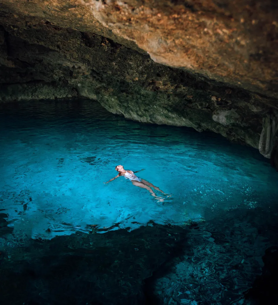 Kayaks beneath the natural arches of the Cova dels Arcs at Cala Moraig